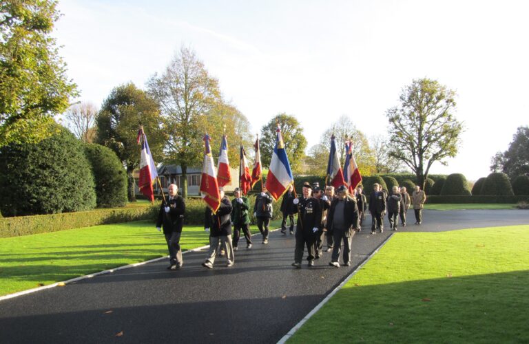 Participants in the 2016 Veterans Day Ceremony at Brittany American Cemetery march in.