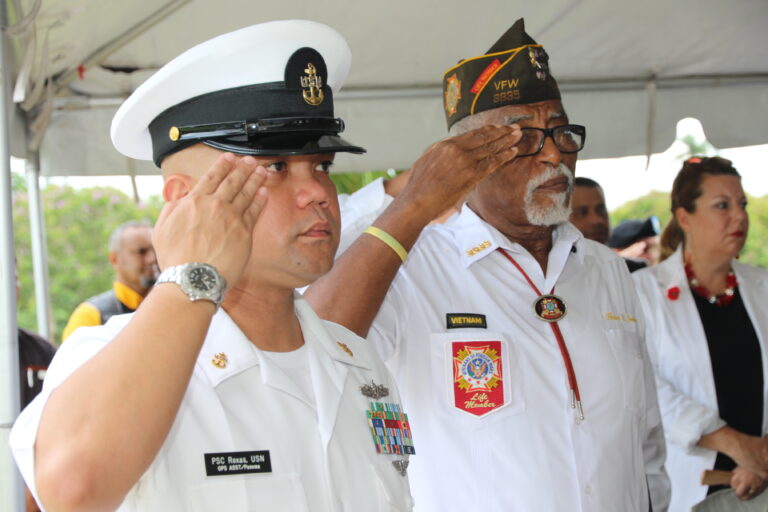 Participants stand and salute during the 2016 Memorial Day Ceremony at Corozal American Cemetery. Photo credit: Miguel Moreno