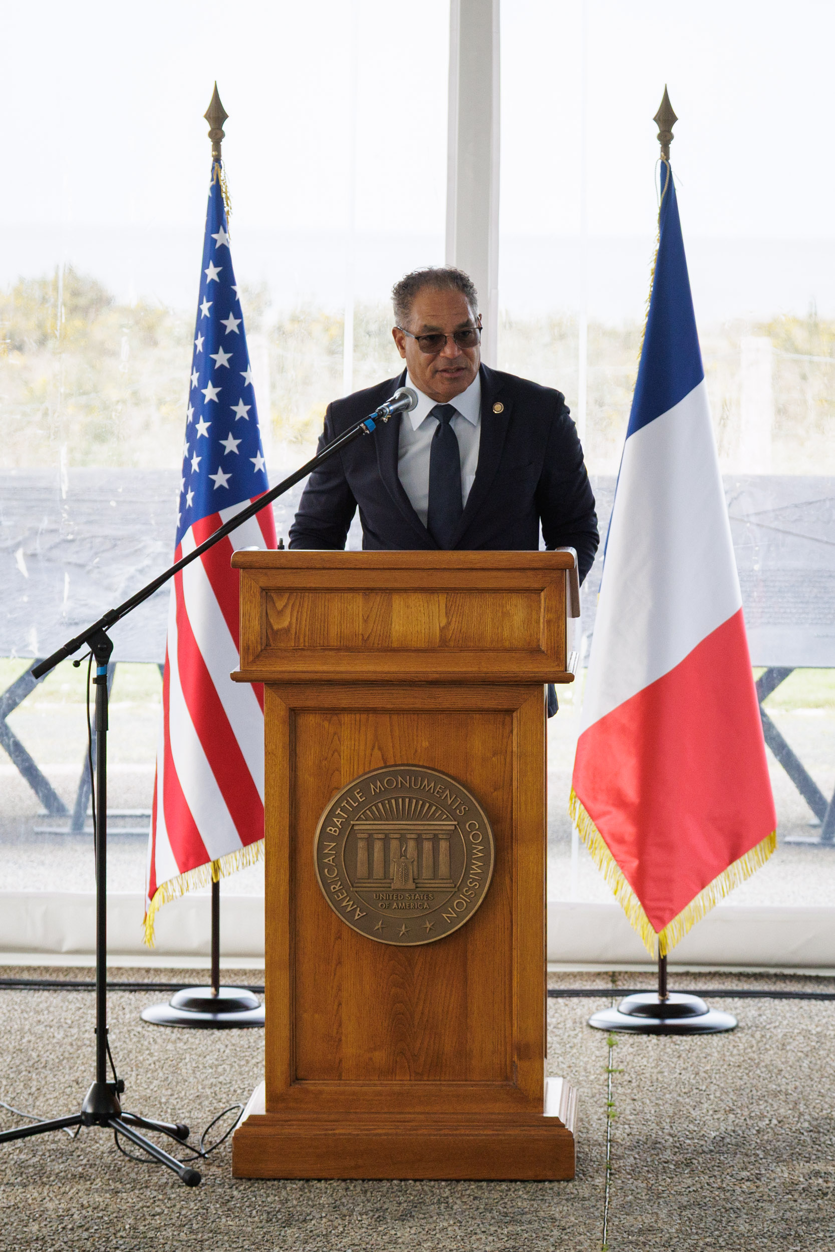 ABMC Chairman Michael X. Garrett delivering remarks at Pointe du Hoc groundbreaking event Feb. 17, 2026. Credit: ABMC/Julien Nguyen-Kim