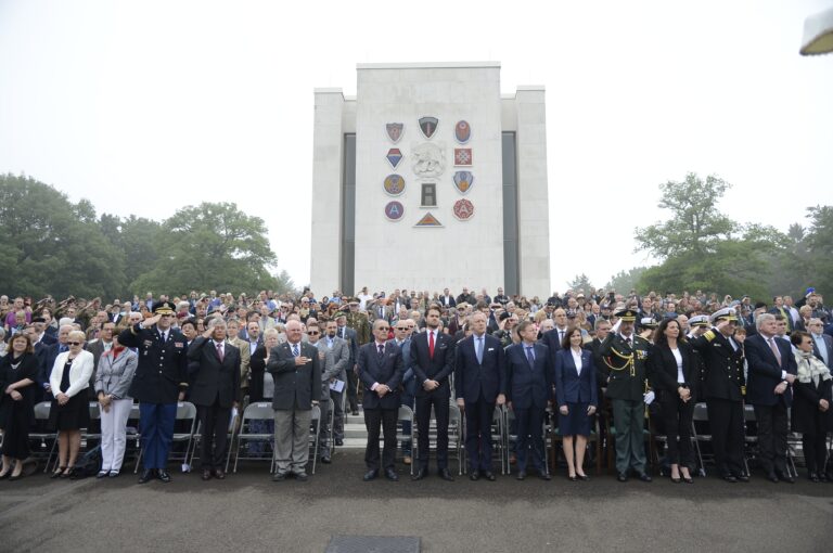 Attendees stand and salute during the national anthem at the 2016 Memorial Day Ceremony at Ardennes American Cemetery. Image courtesy of Brussels Embassy