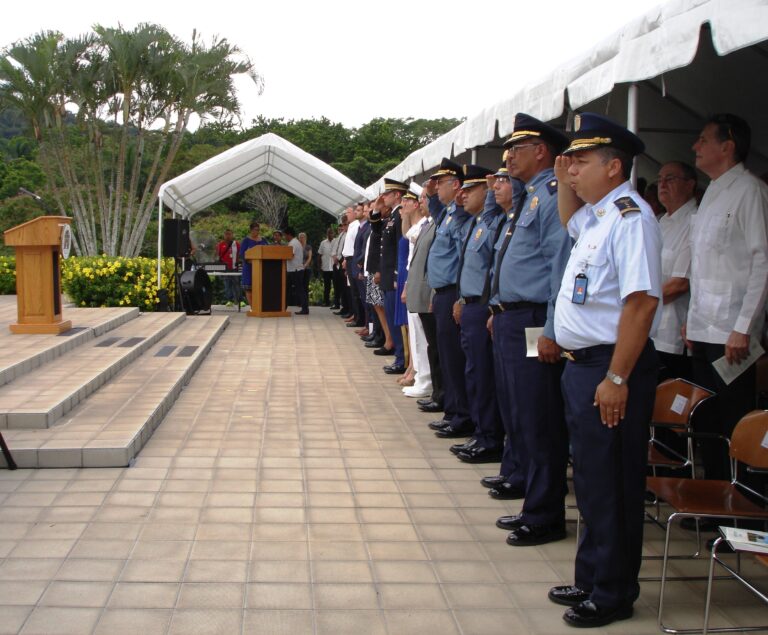 Participants stand and salute during the 2016 Memorial Day Ceremony at Corozal American Cemetery.