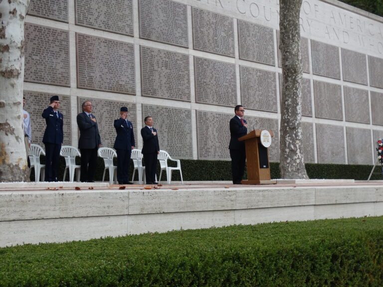 Assistant Superintendent Angel Matos stands at the podium during the 2015 Veterans Day Ceremony at Florence American Cemetery.