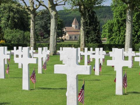 American and French flags stand in front of every marble headstone.