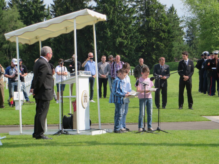 Students participate in the 2016 Memorial Day Ceremony at Henri-Chapelle American Cemetery.