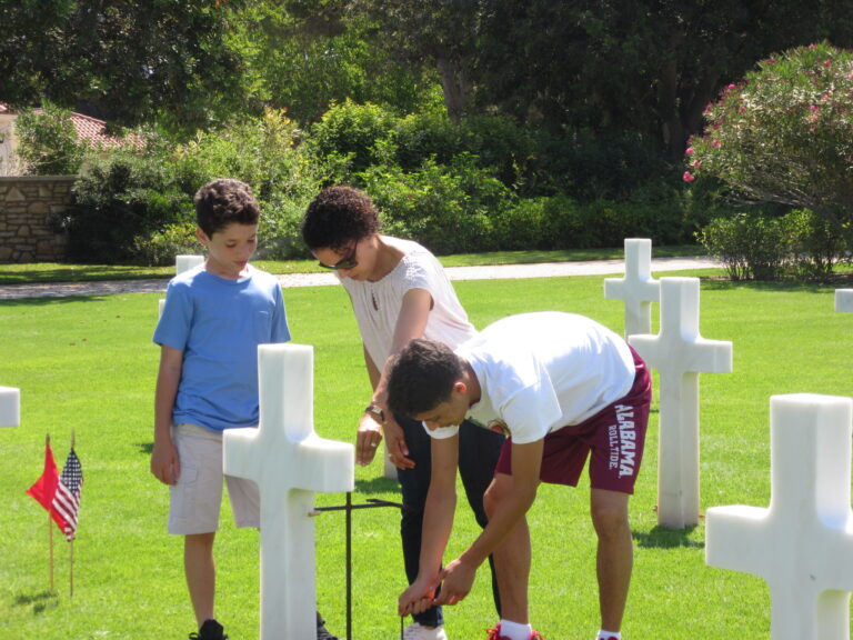 Volunteers help place American and Tunisian flags in front of every headstone at North Africa American Cemetery in preparation for the 2017 Memorial Day Ceremony.