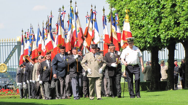 French veterans march in with flags during the 2017 Memorial Day Ceremony at St. Mihiel American Cemetery.