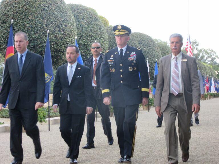 Members of the official party march in during the 2016 Veterans Day Ceremony at North Africa American Cemetery.