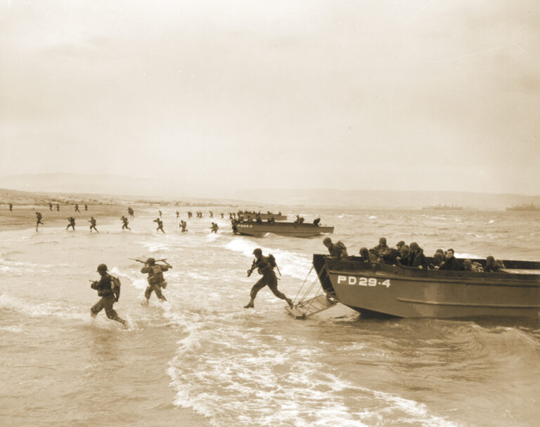 American soldiers plunge into the surf and wade to Utah Beach