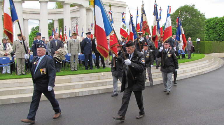 Members of the Porte Drapeaux walk with flags during the 2016 Memorial Day Ceremony at St. Mihiel American Cemetery.