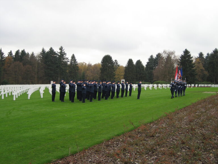 Members of the U.S. military salute as the color are posted during the 2015 Veterans Day Ceremony at Luxembourg American Cemetery.