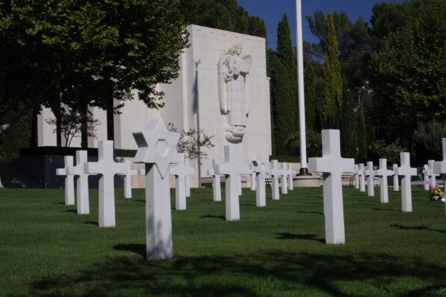 Picture of Rhone American Cemetery with some headstones in the front and the chapel in the back. Credit: American Battle Monuments Commission/ Robert Uth.