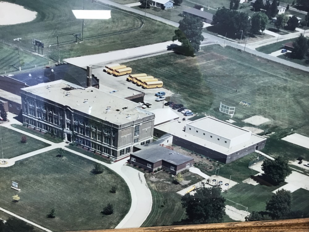 Aerial view of the Glidden Ralston School in 1966, showing the school campus with buildings and school buses, surrounded by lawns and roads.