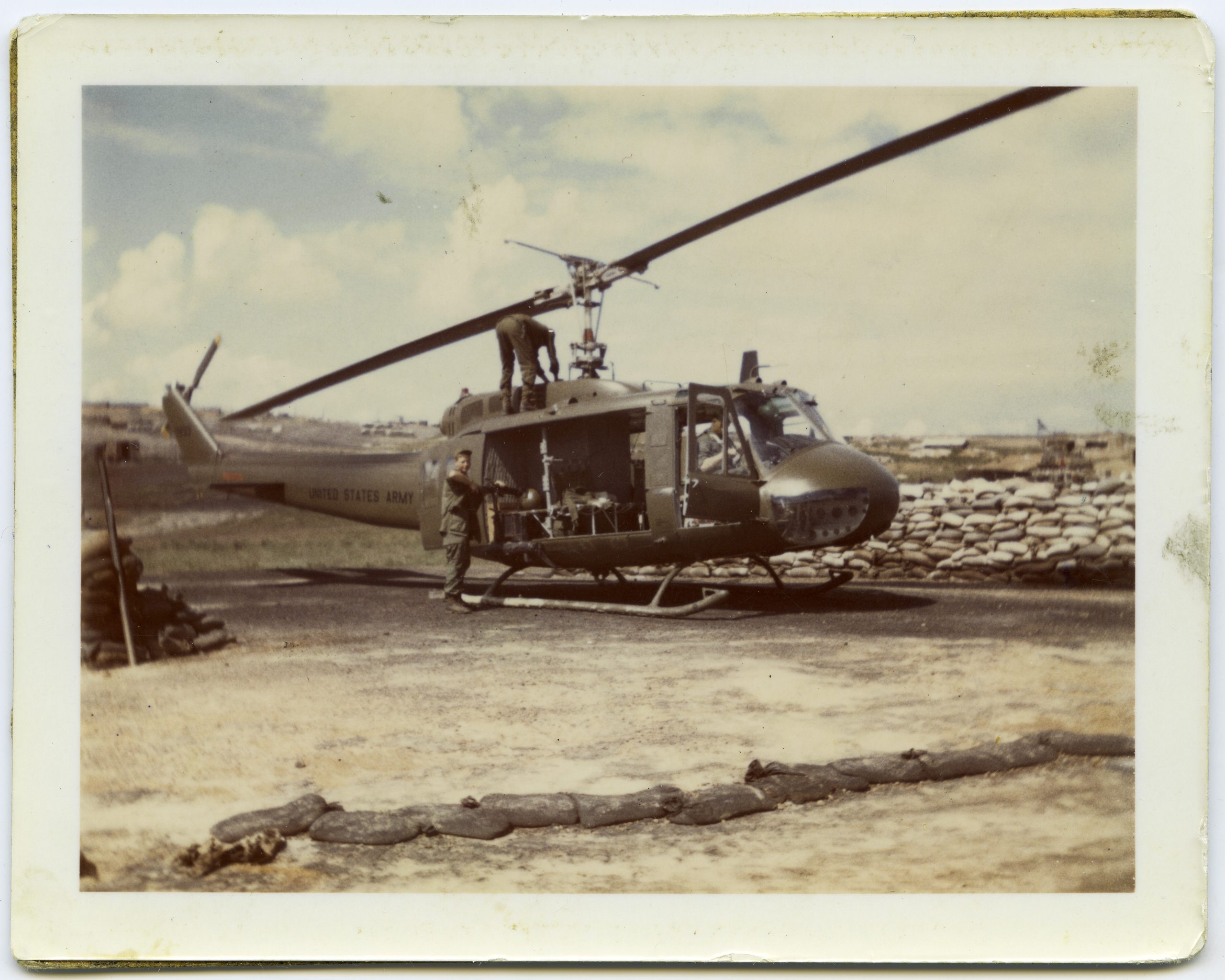 HU-1 (Huey) helicopter with the gunner putting the barrel on an M-60 machine gun at Camp Evans in Vietnam, December 4, 1968