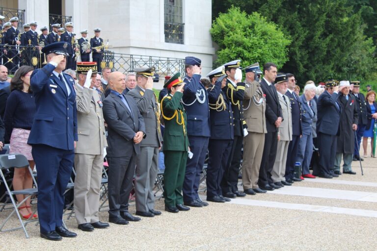 Military representatives stand and salute during the 2016 Memorial Day Ceremony at Suresnes American Cemetery. Image courtesy of Emily Munsel.